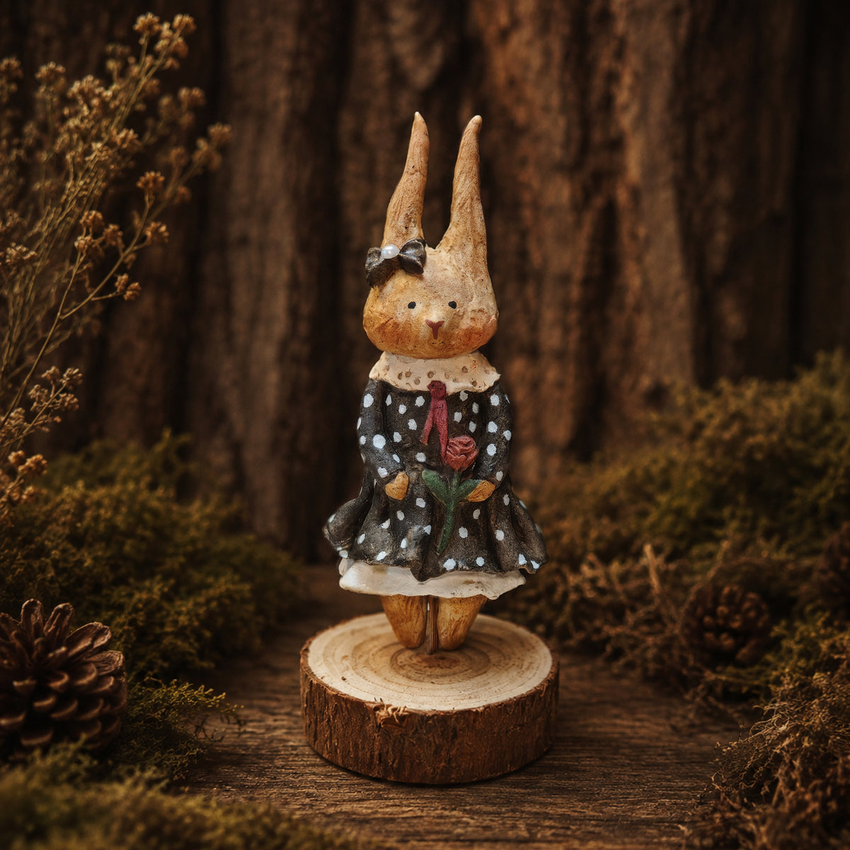 Willowwick rabbit doll in a black polka-dot dress with red details and a small black headpiece.