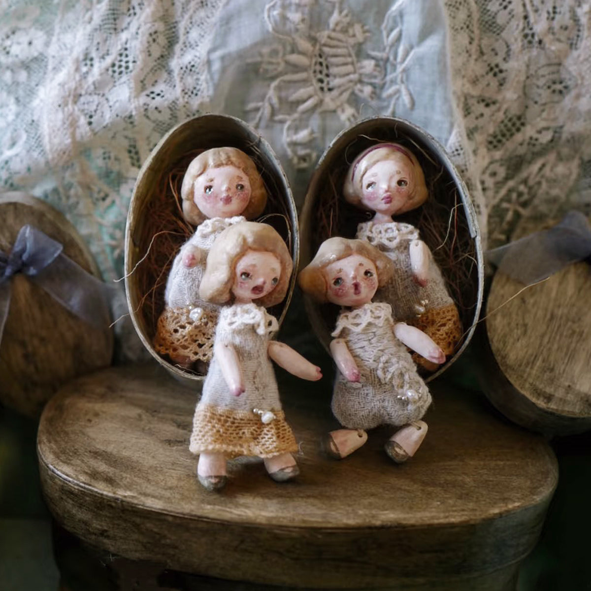 Four miniature Lambwick resident dolls displayed in small oval presentation boxes.