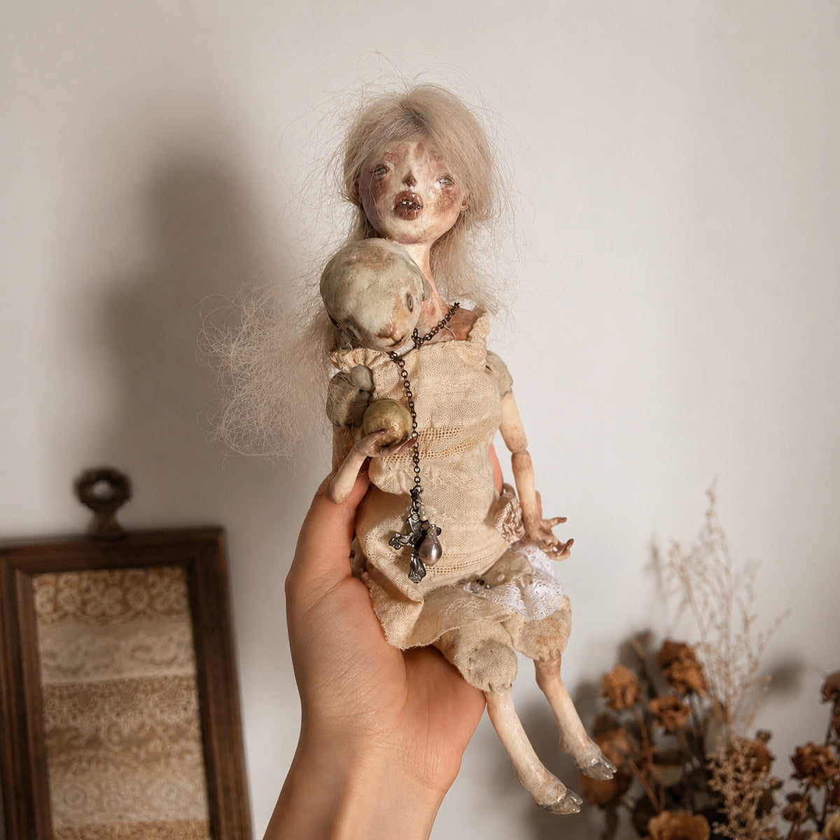 Lambwick art doll with long pale hair and a small lamb companion, held upright.