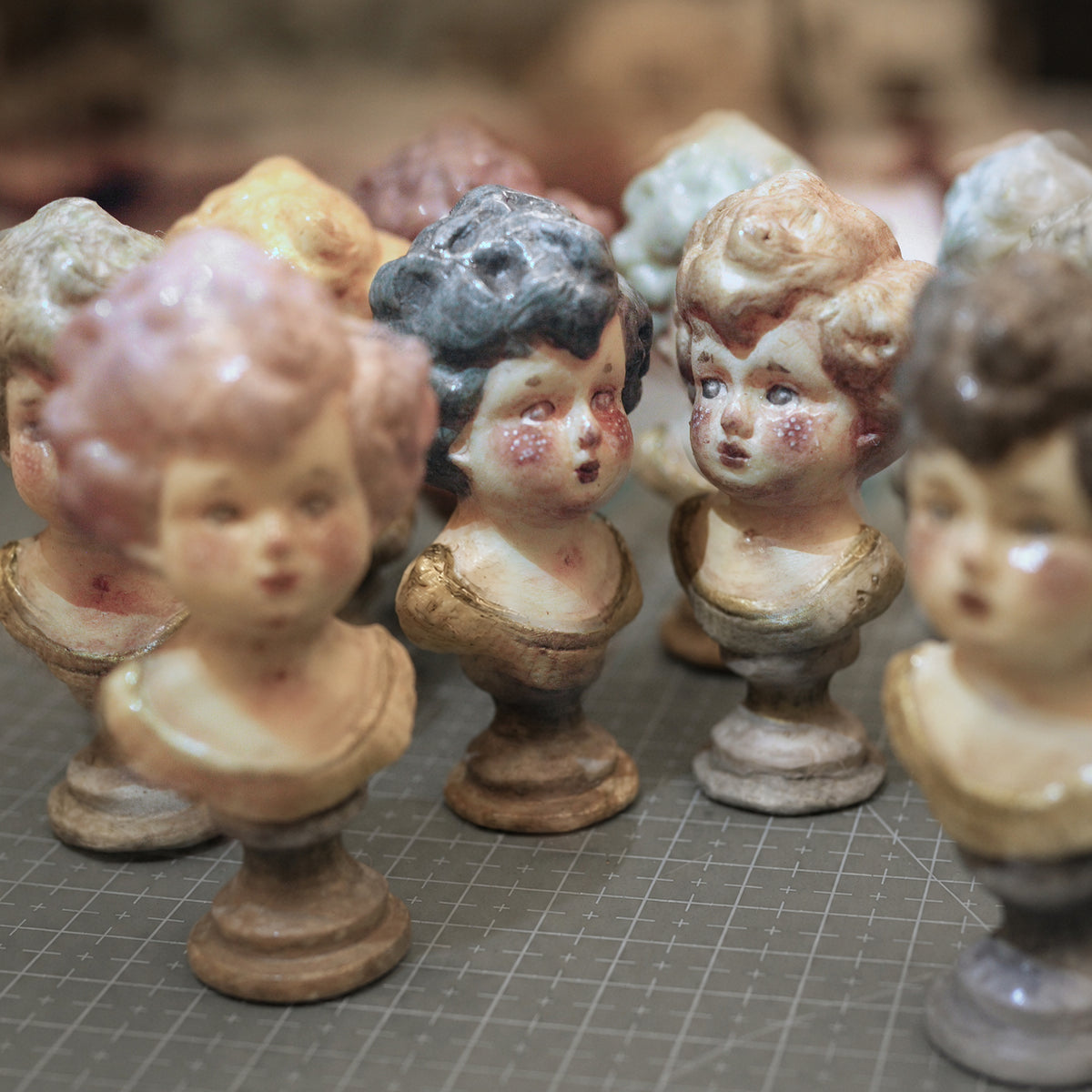Lambwick miniature portrait busts with different hair colors and expressions arranged in a row.