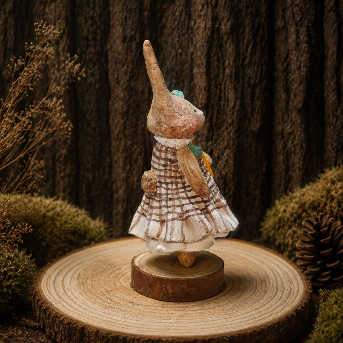 Side view of a Willowwick rabbit doll in a checked dress and green scarf.
