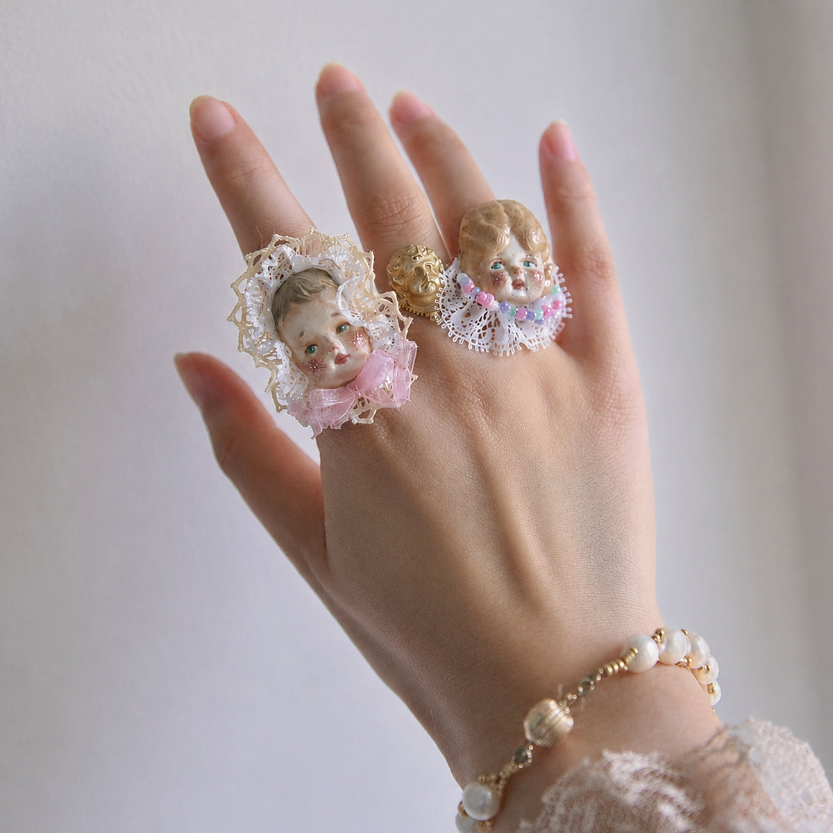 Lambwick Giant Baby and Pumpkin Head doll rings shown on an outstretched hand.