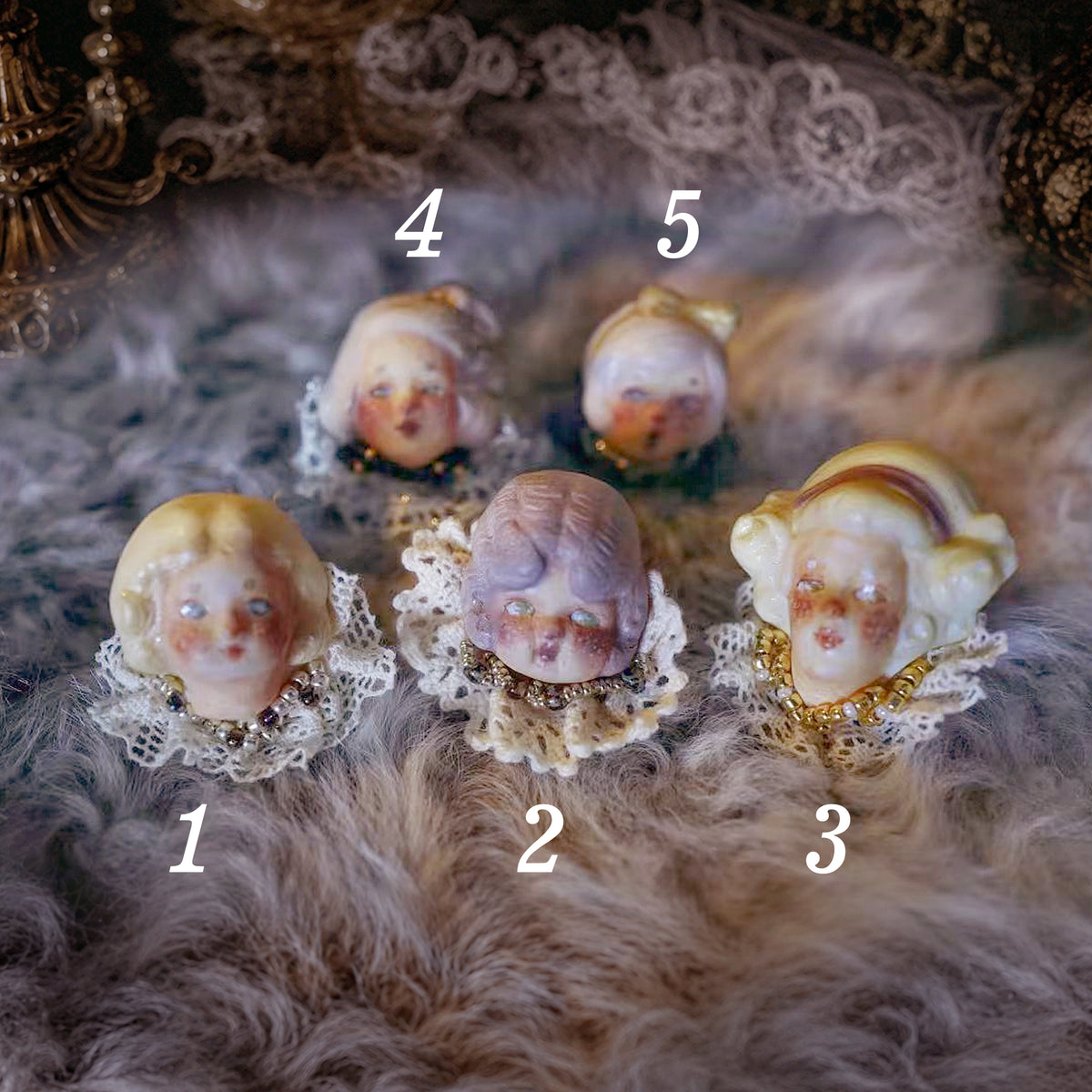 Numbered comparison of five Lambwick doll ring designs with different hair and bonnet styles.