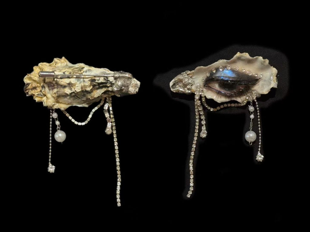 Front-and-back comparison of a Lilith Veil Black & White Smoky shell-eye piece with draped chains.