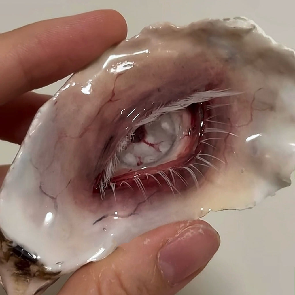 Close-up of Lilith Scarlet Wound showing red vein details, a pale iris and fine lashes.