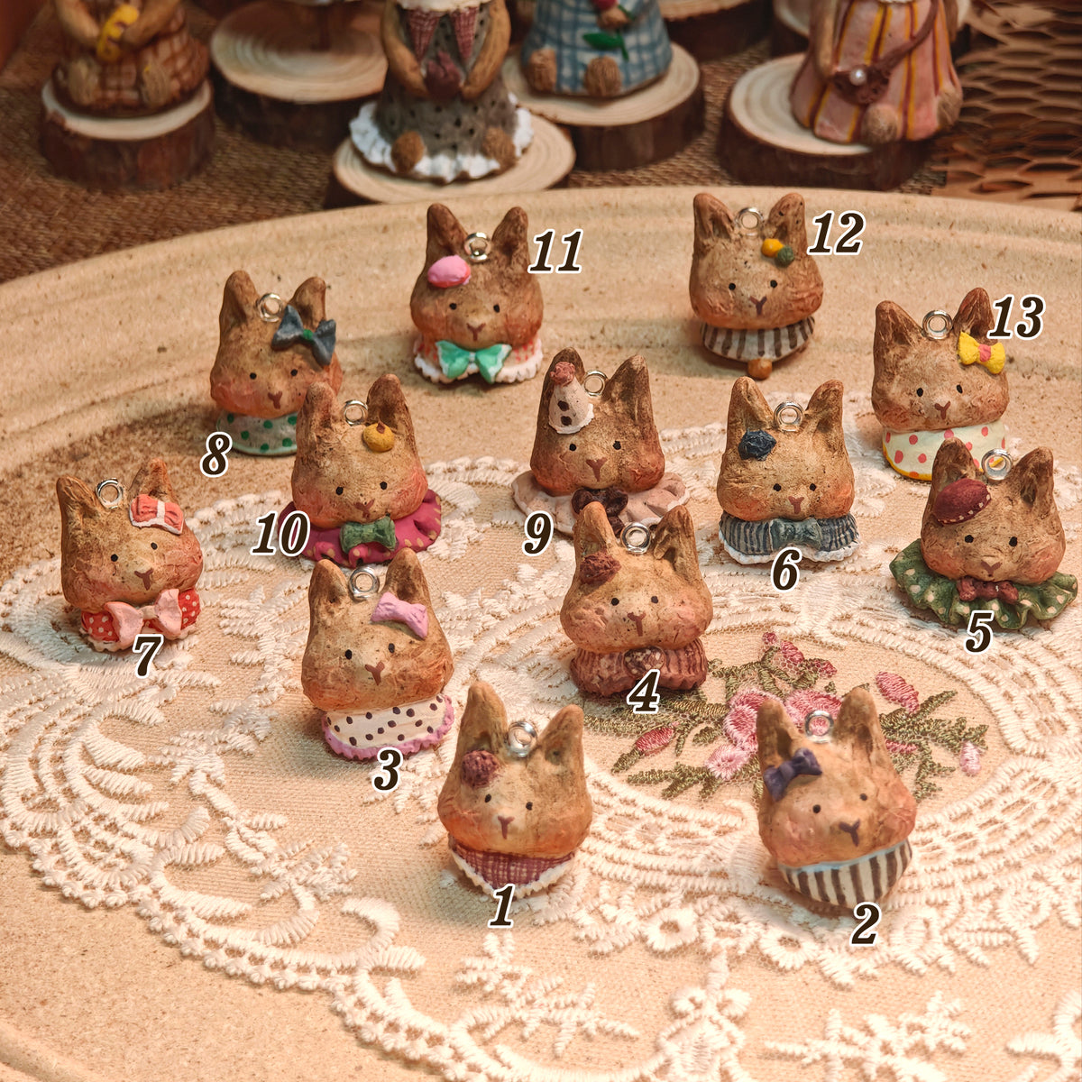 Numbered comparison chart of thirteen Winterwood rabbit pendant designs.