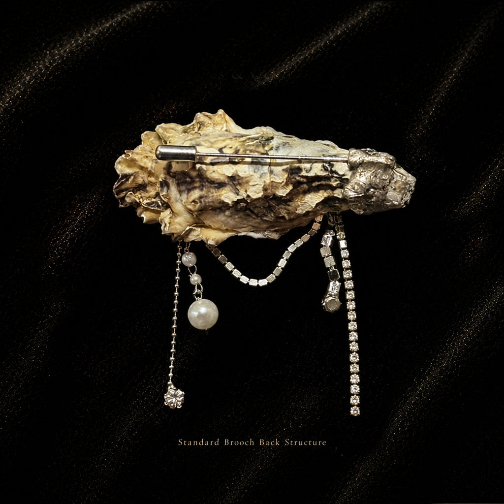 Rear brooch-pin structure of a shell-eye piece with long decorative chains.