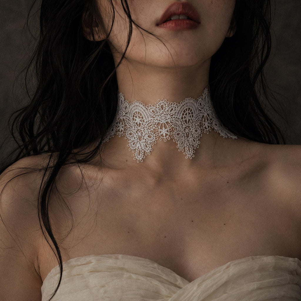 Wide ivory floral-lace choker shown worn above a pale neckline.