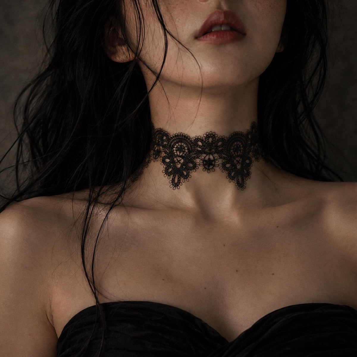 Wide black floral-lace choker shown worn above a dark neckline.