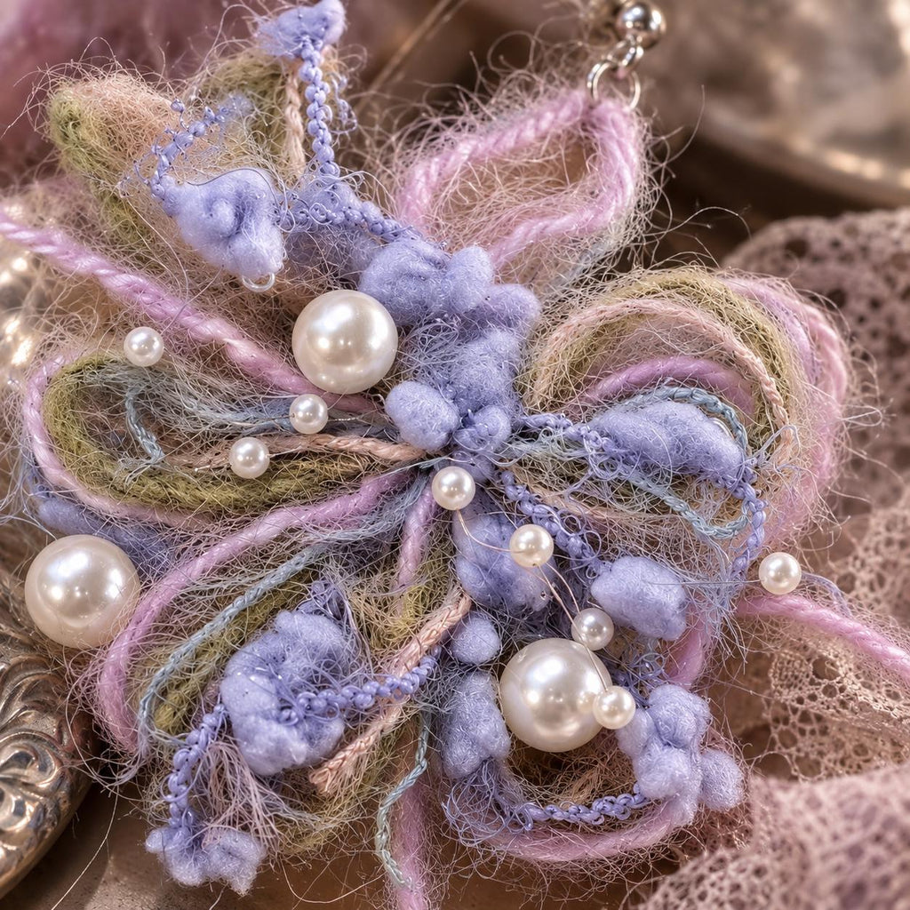 Close view of the lavender yarn loops, white pearl-like beads and small bead trim.