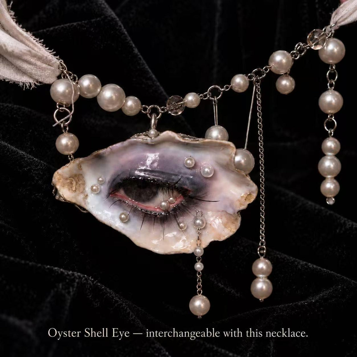 Reference necklace showing an interchangeable oyster-eye pendant with pearl-like beads and chains; pictured eye differs from Nyx Cat.