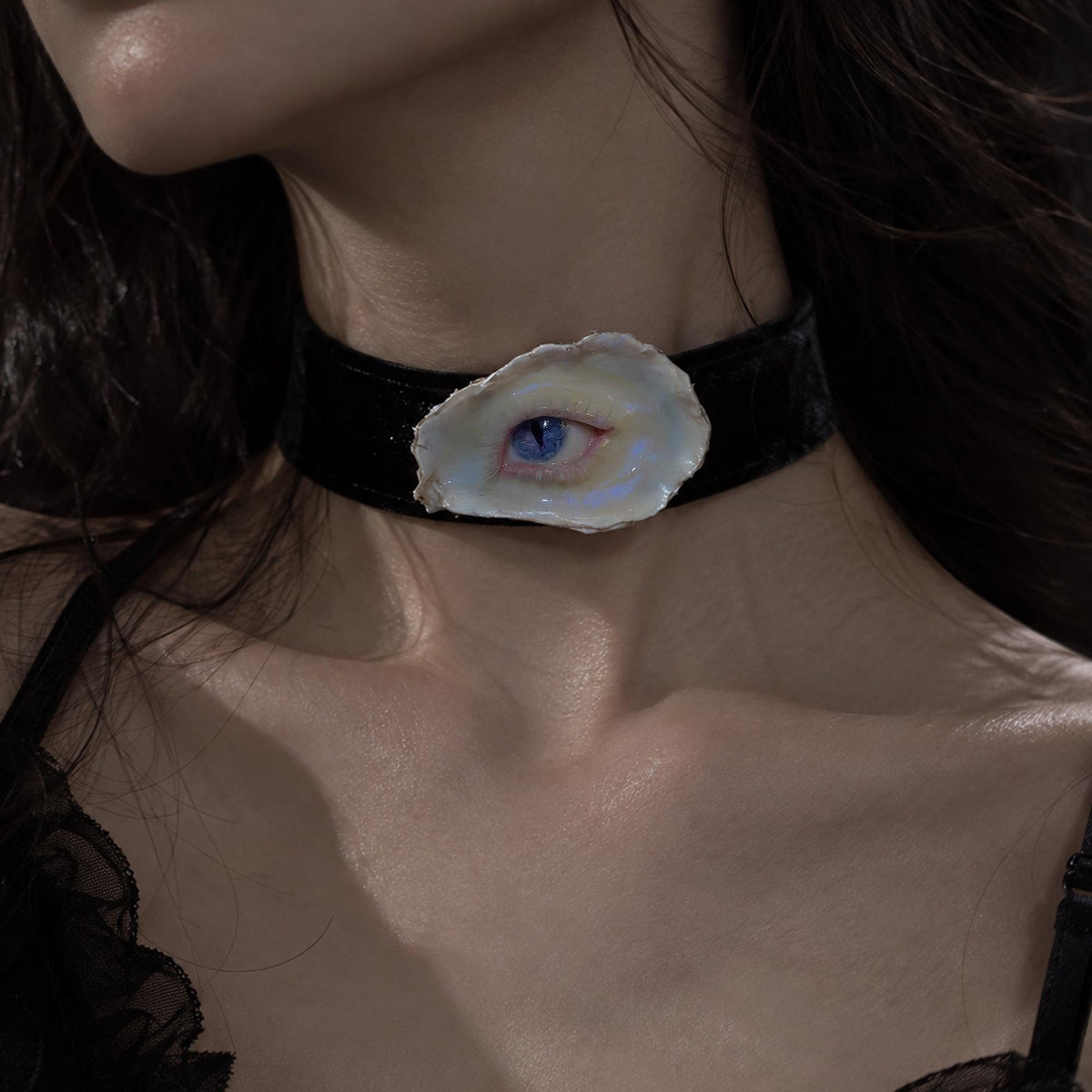 Nyx Cat blue-eye shell jewelry worn as a black velvet choker.