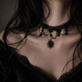 Black gothic choker with beaded loops and a dark teardrop pendant shown worn.