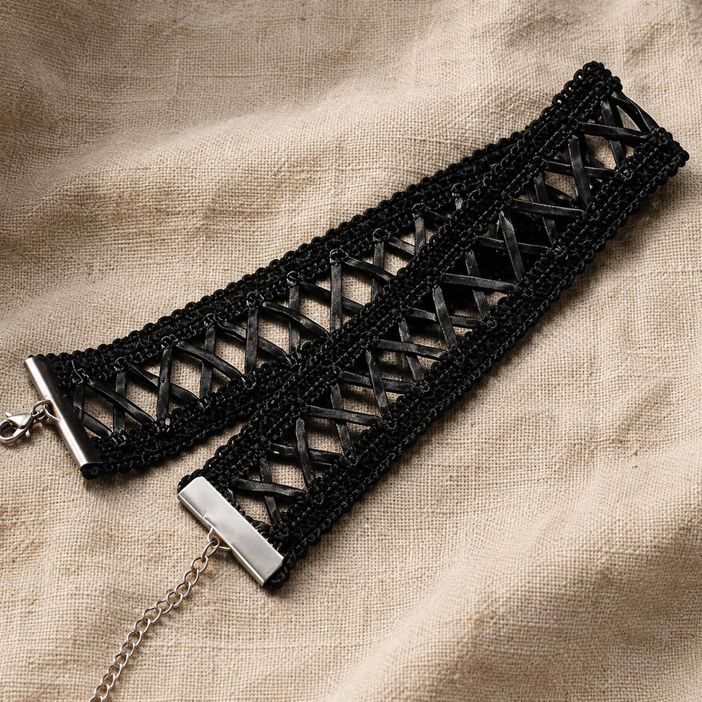 Black lace-up ribbon choker laid flat to show the crisscross lacing and clasp.