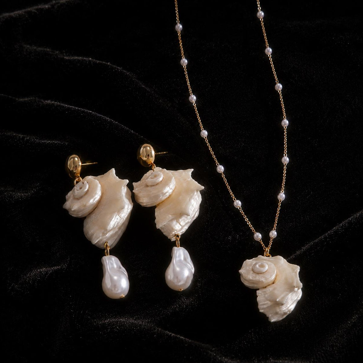 Conch-shell necklace arranged with a pair of pale bead-drop shell earrings.