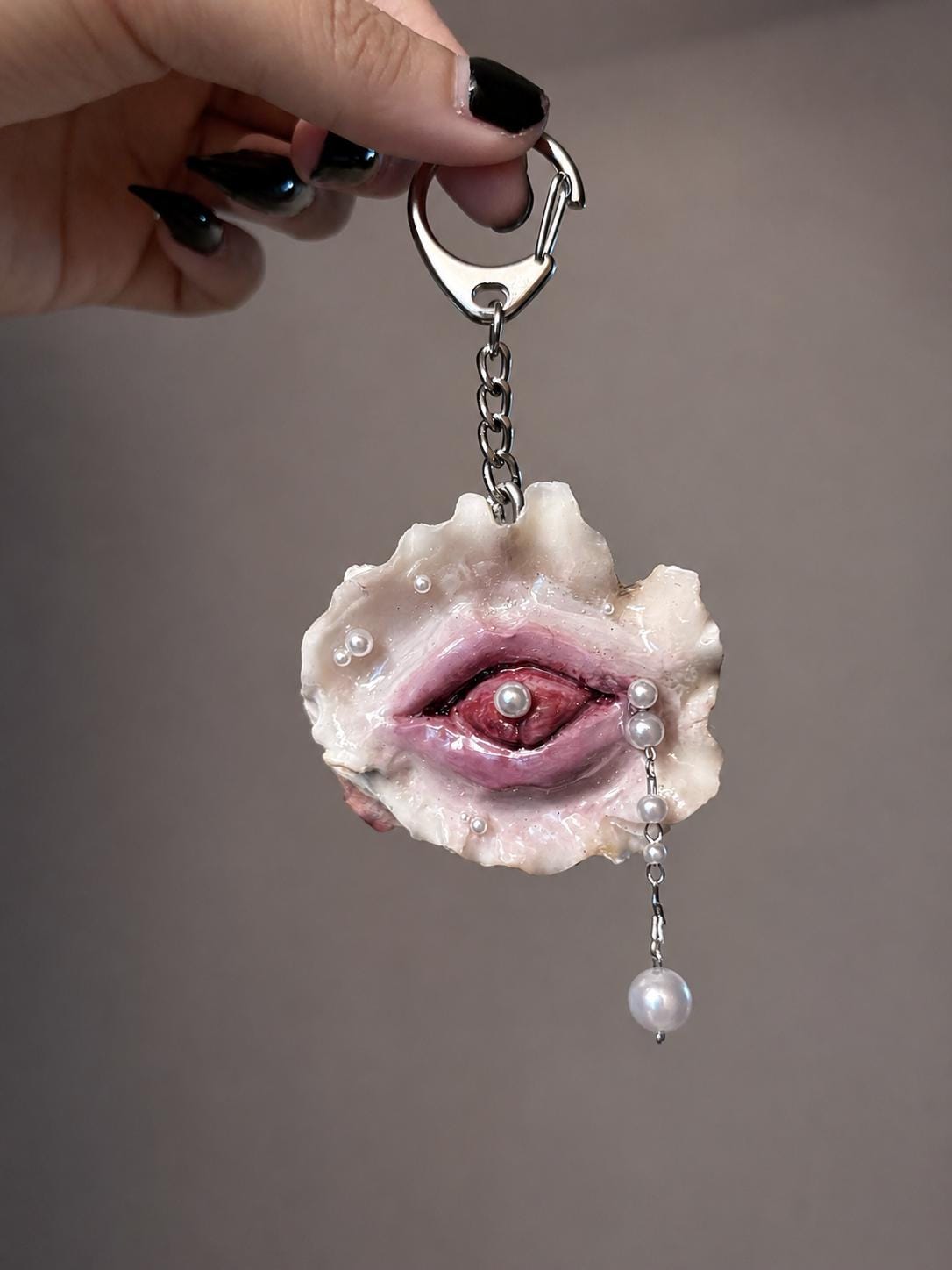 Shell Mouth Relic hanging from a metal keychain attachment.