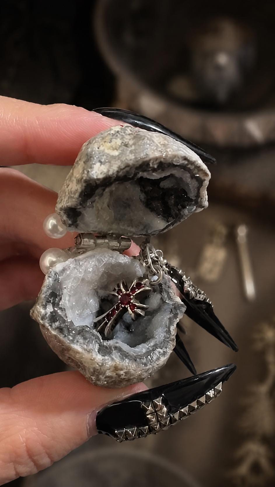 Open Geode Shell Trinket Box held in a hand with small rings inside.
