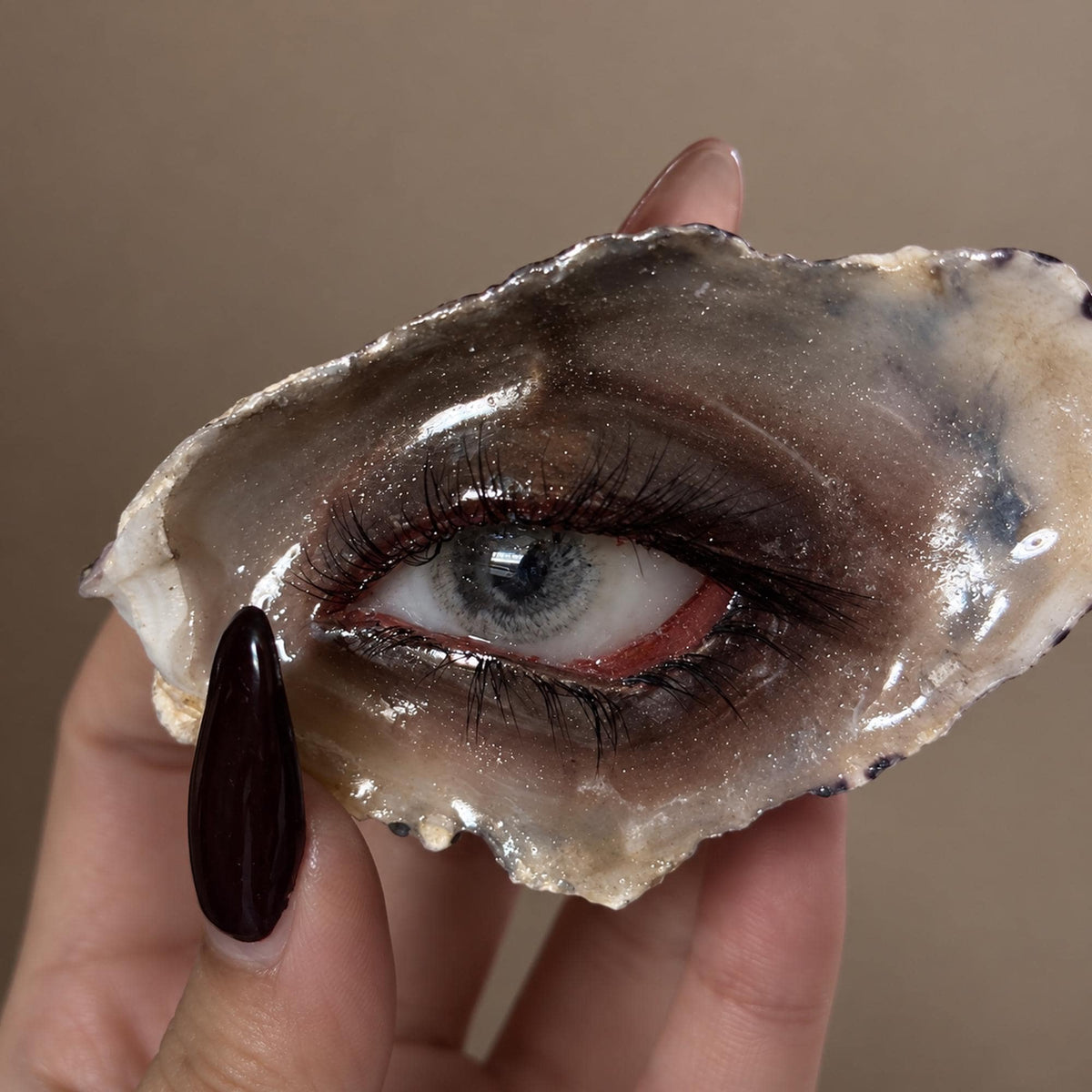 Close-up of Lilith Grey Temptation showing the grey iris, red inner corner and smoky makeup.